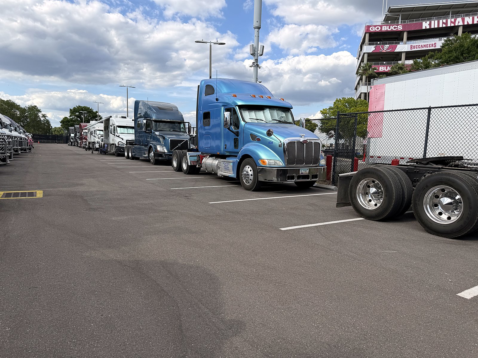 Blue CW Peterbilt tractor in a parking lot